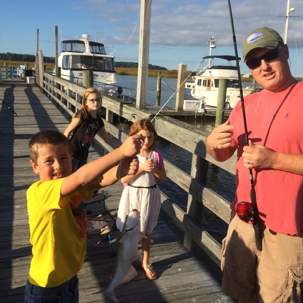 Father and children with fish