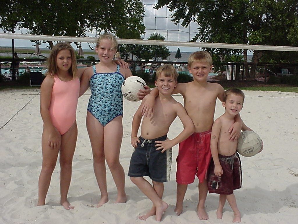 Kids playing beach volleyball