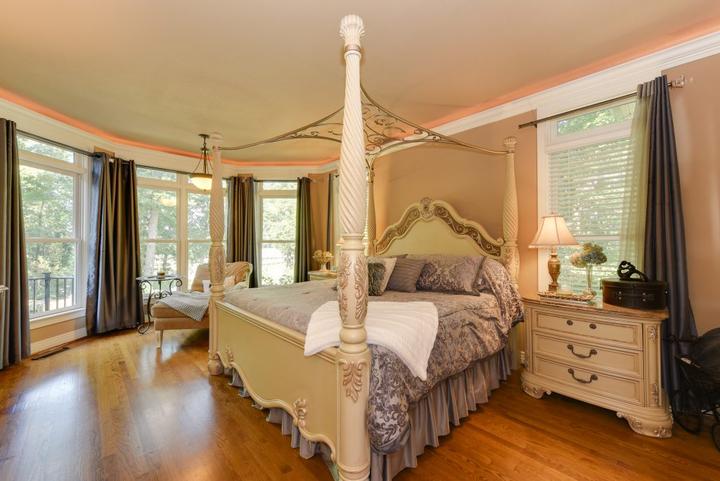 master bedroom with pencil post bed