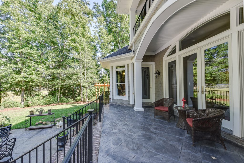 arched back door with stone patio
